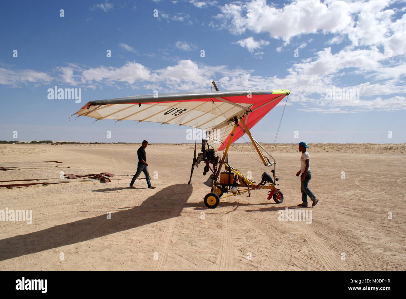 Two men get a Microlight plane ready for a flight over the Sahara desert, Douz, Kebili district, Tunisia Stock Photo