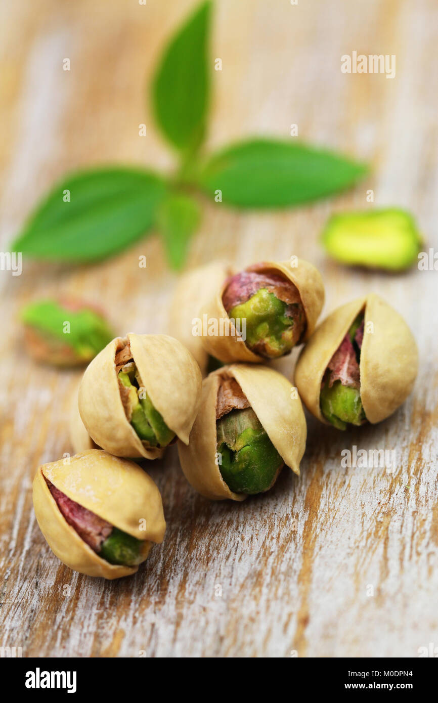 Nutritious pistachio nuts on rustic wooden surface Stock Photo