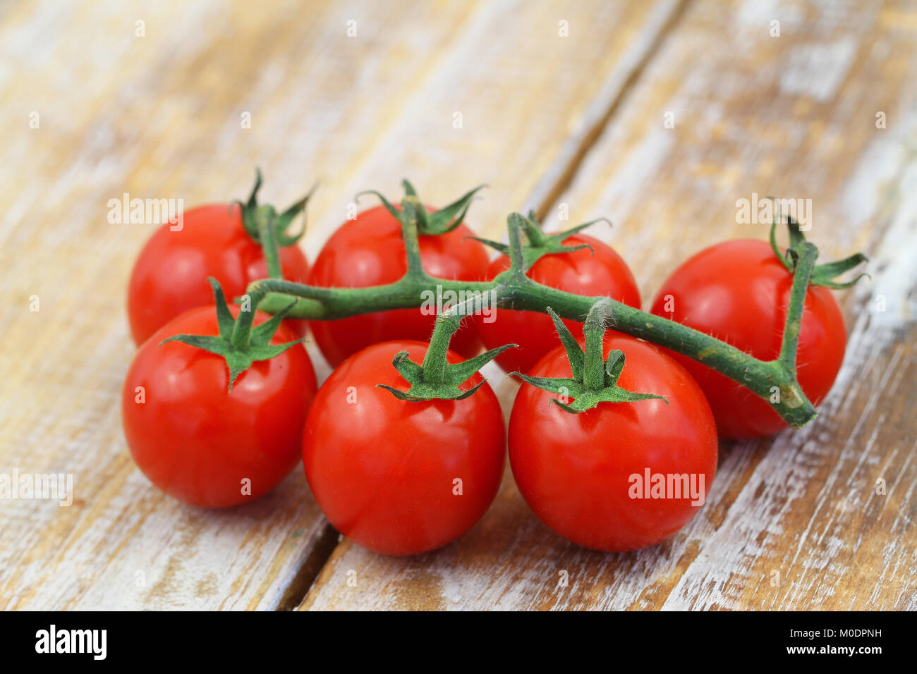 Ripe cherry tomatoes on rustic wooden surface, closeup Stock Photo