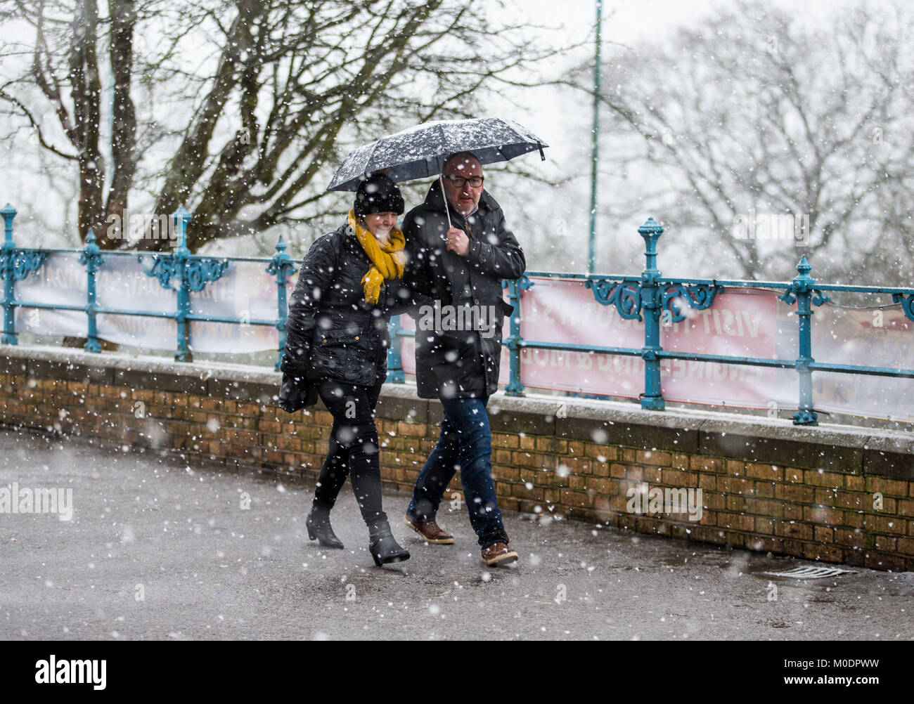 People walk during a snowfall at Alexandra Palace, London, as people across the country are braced for more snow after the UK froze on the coldest night in nearly two years. Stock Photo