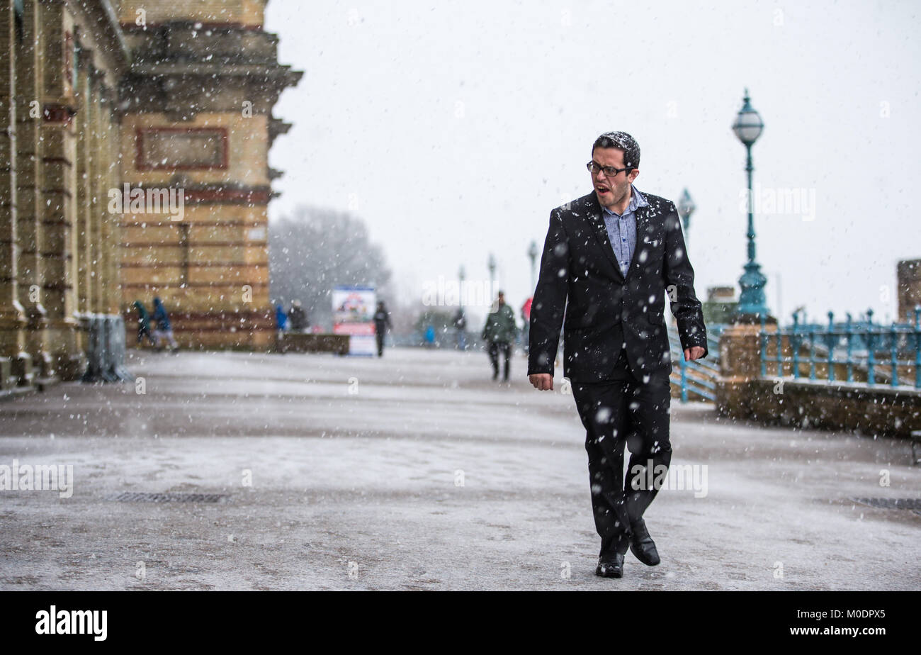 A man walks during a snowfall at Alexandra Palace, London, as people across the country are braced for more snow after the UK froze on the coldest night in nearly two years. Stock Photo