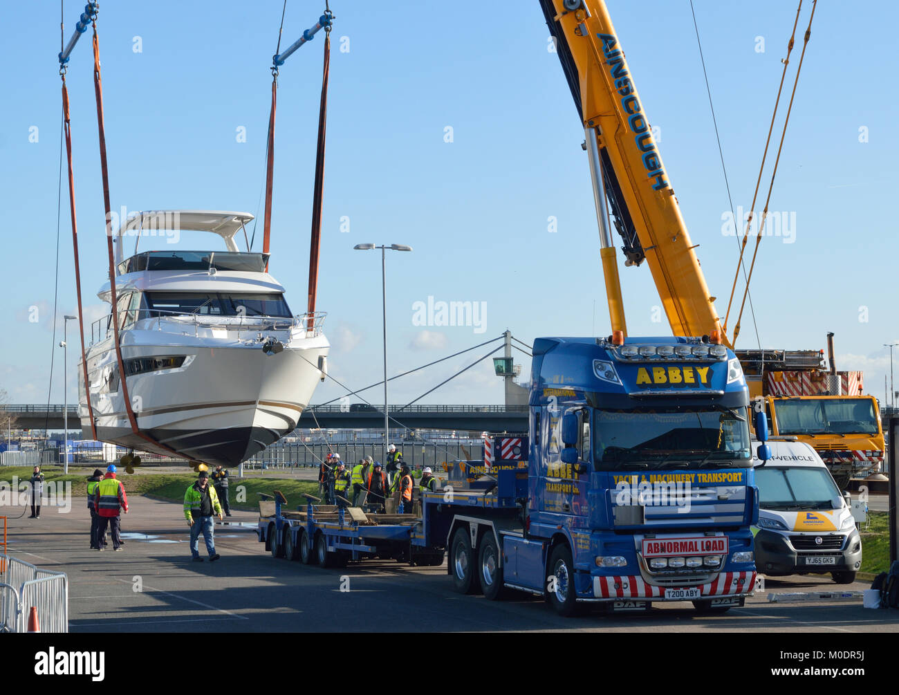 Crane lifting boats back in to the water after they have attended the