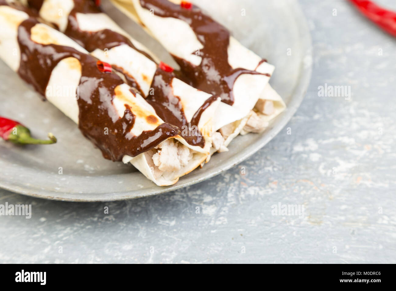 Mexican chicken enchiladas with chili chocolate salsa mole poblano