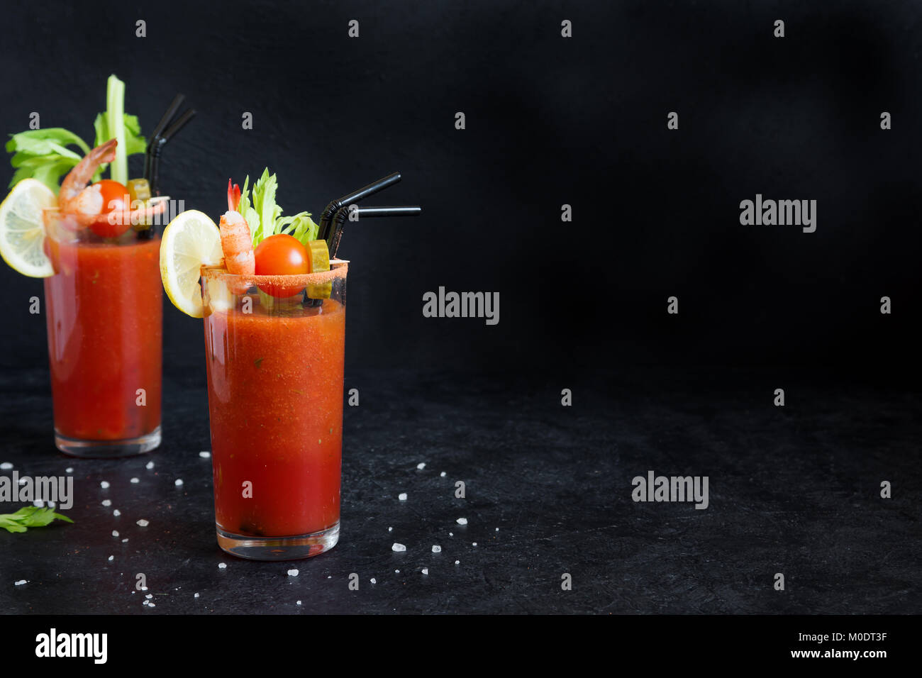 Bloody Mary Cocktail in glasses with garnishes. Tomato Bloody Mary