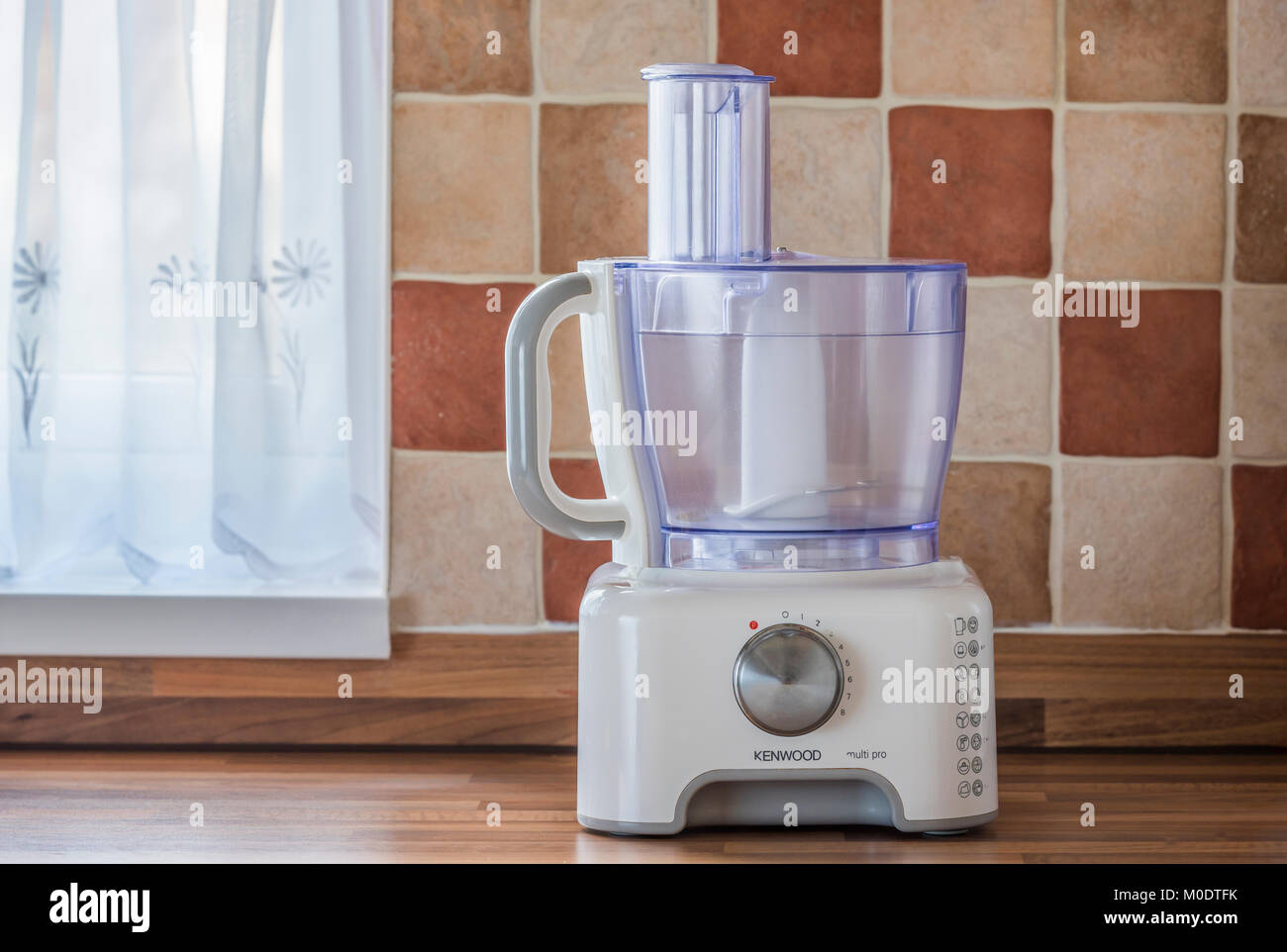 Kenwood multi pro food mixer or processor, on kitchen worktop with tiled background. Houshold electrical appliance. Stock Photo