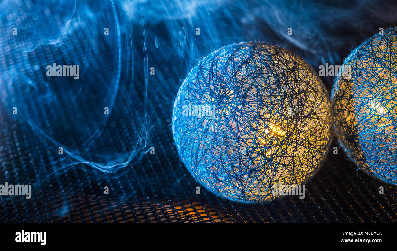 Close-up of balls from black fibers on a net with dense smoke. Light trapped inside the spheres. Science fiction, fantasy, technology, industry idea. Stock Photo
