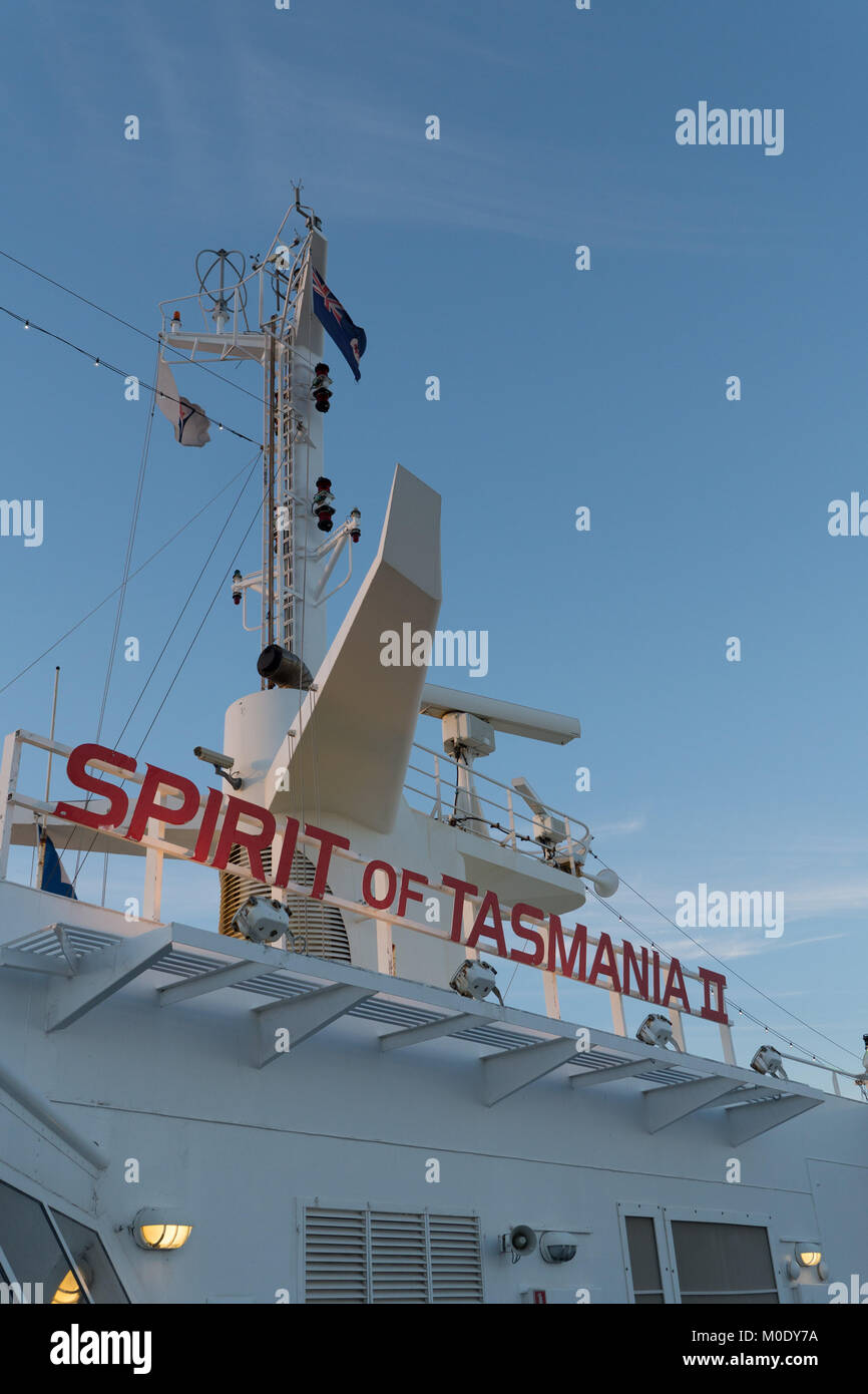 Exterior photos of Spirit of Tasmania II name on bridge in red letters with blue sky and windswept flags and white antennae and radar. Stock Photo