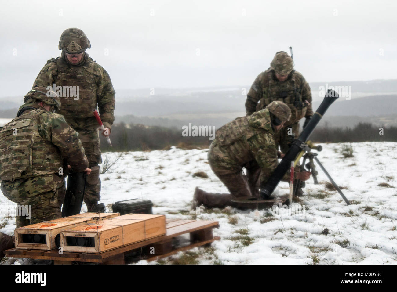 U.S. Soldiers assigned to Headquarters and Headquarters Company, 1st Battalion, 503rd Infantry Regiment, 173rd Infantry Brigade Combat Team (Airborne), fire the M252A1 81mm Mortar System at Mortar Firing Point 1 in the Baumholder Military Training Area, Germany, Jan. 18, 2018. The training provided the Mortarmen the opportunity to increase their proficiency and familiarization with the weapon system. The 173rd Airborne Brigade is the U.S. Army’s Contingency Response Force in Europe, providing rapidly deploying forces to the U.S. Army Europe, Africa and Central Command Areas' of Responsibility  Stock Photo