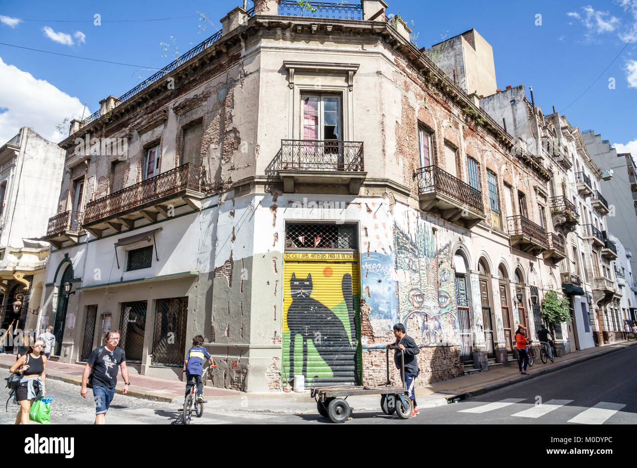 Buenos Aires Argentina,San Telmo,historic center,building,dilapidated,mural,street art,graffiti,corner,pedestrians,Black cat,Hispanic ARG171119332 Stock Photo