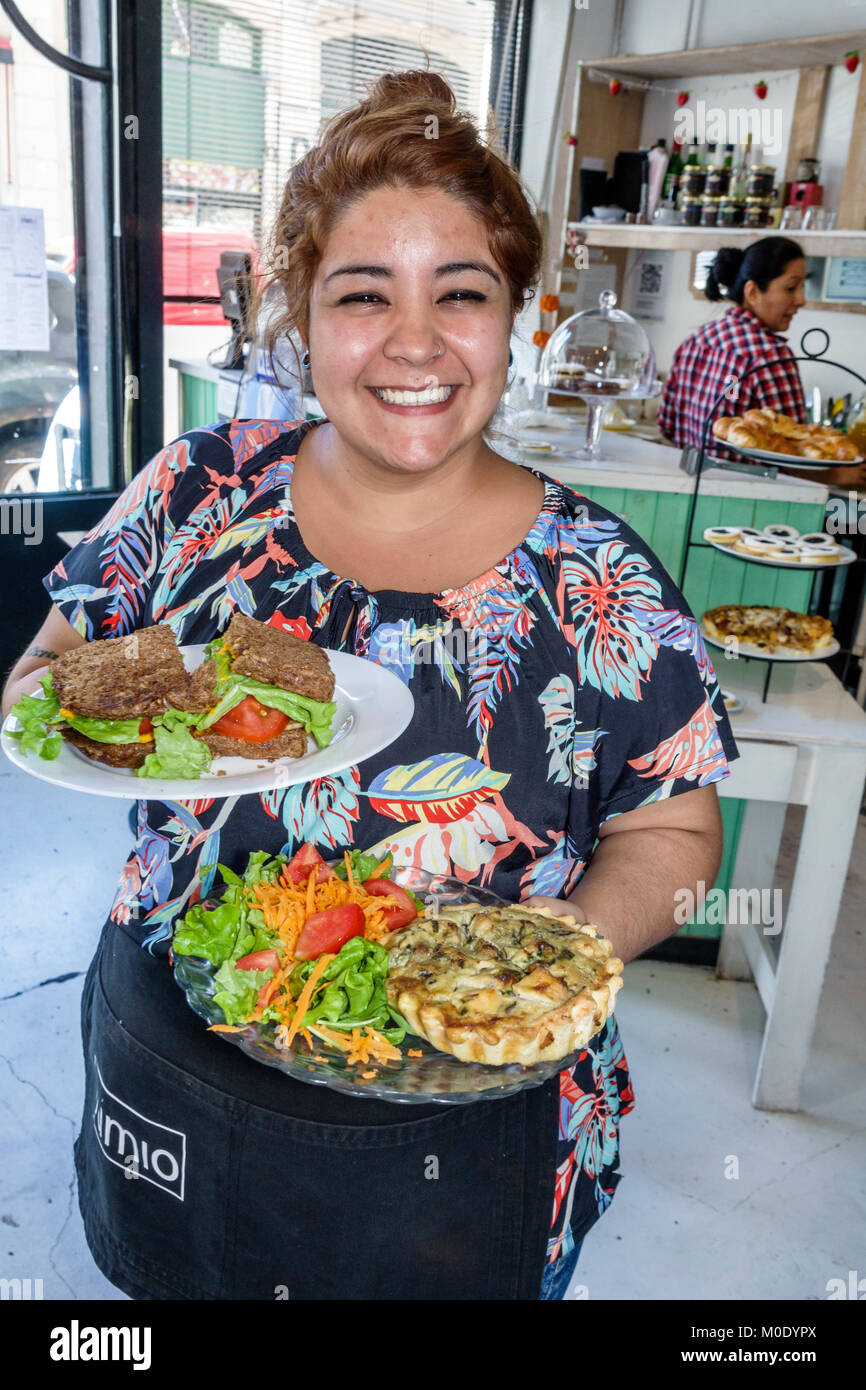 Buenos Aires Argentina,San Telmo,Lumio Cafe Y Delicias,restaurant food plates,Hispanic woman female waitress server employee worker serving quiche Stock Photo