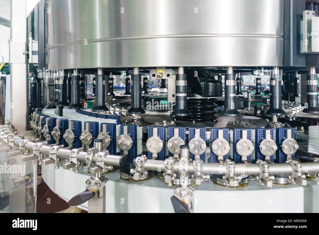 Automated labeling machine equipment with conveyor belt in a beverage factory Stock Photo