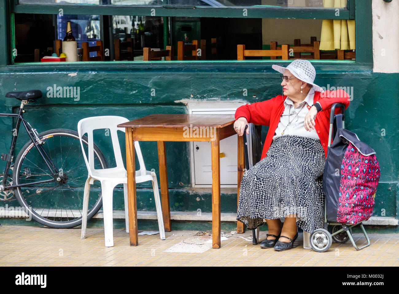 Buenos Aires Argentina,San Telmo,sidewalk,cafe,table,woman female women,senior seniors citizen citizens,sitting,shopping cart,Hispanic ARG171119375 Stock Photo