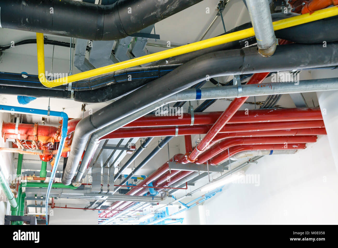 Red Water pipe system. Pumping systems for industrial plants. Construction  work. Installation of pipeline extinguishing water in the building. Mainten  Stock Photo - Alamy, image size:1300x956