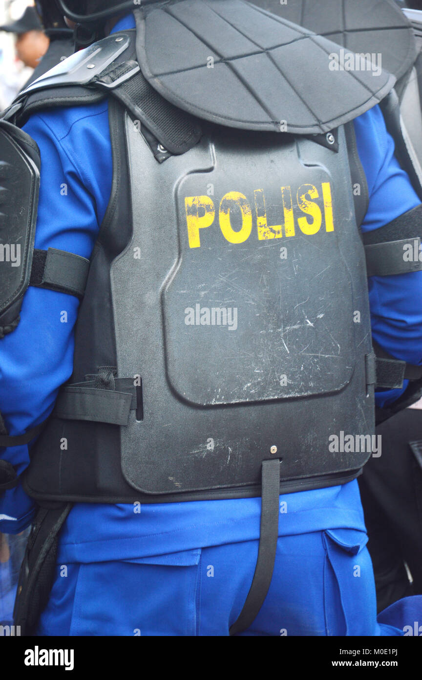 Indonessian Police wearing black anti-riot safety vests Stock Photo - Alamy