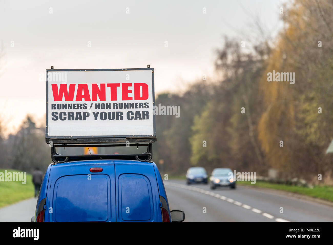 Wanted Runners Non Runners Scrap Your Car sign on car roof next to UK motorway. Stock Photo
