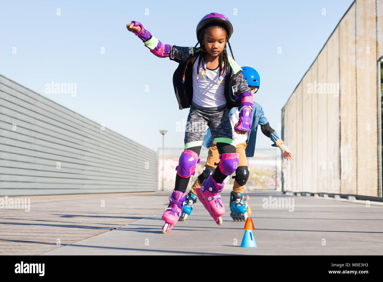 Girl learning to slalom skate with inline skates Stock Photo Alamy
