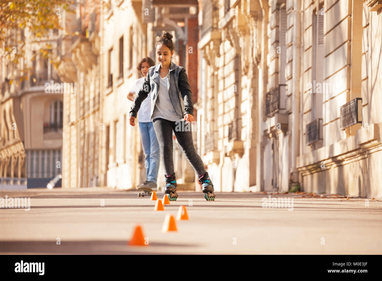 Teenage girl roller skating at city side walk Stock Photo Alamy
