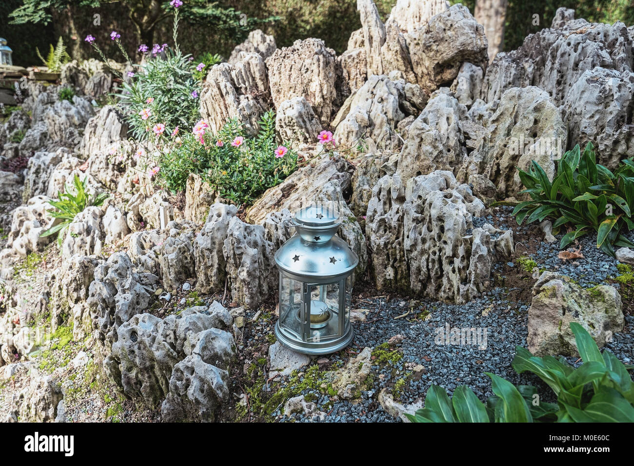 Rock garden decorated with candle holders Stock Photo Alamy