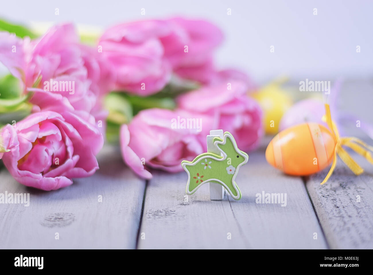 Easter composition of pink roses, colored Easter eggs and a Easter ...