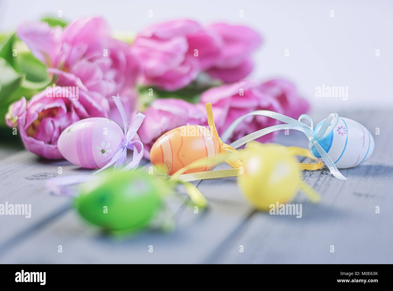 Easter composition of pink roses and colored Easter eggs Stock Photo ...