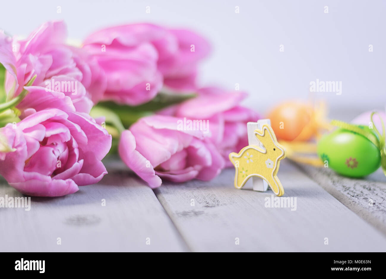 Easter composition of pink roses, colored Easter eggs and a Easter ...