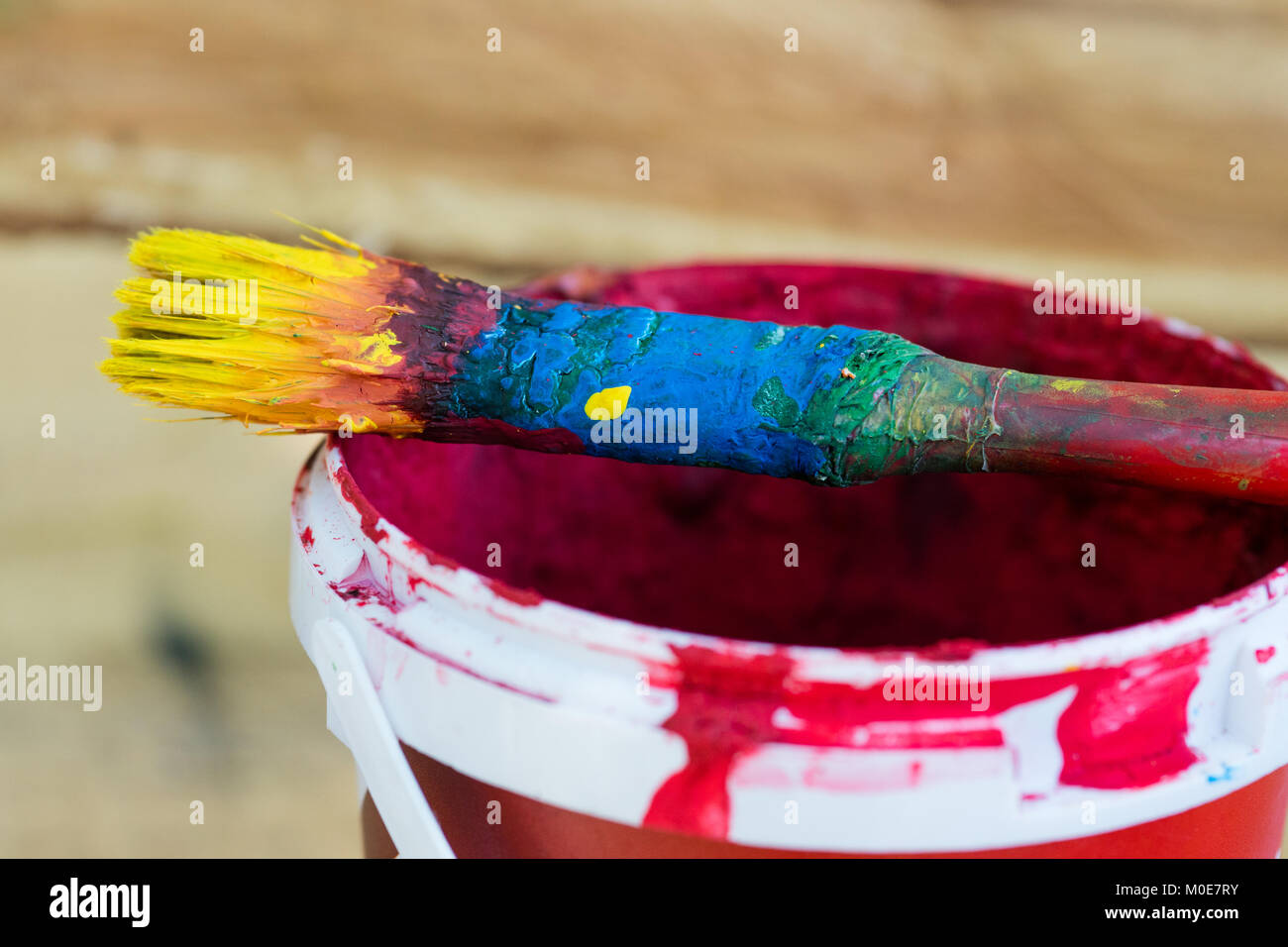 Paintbrush in a can with red paint Stock Photo Alamy