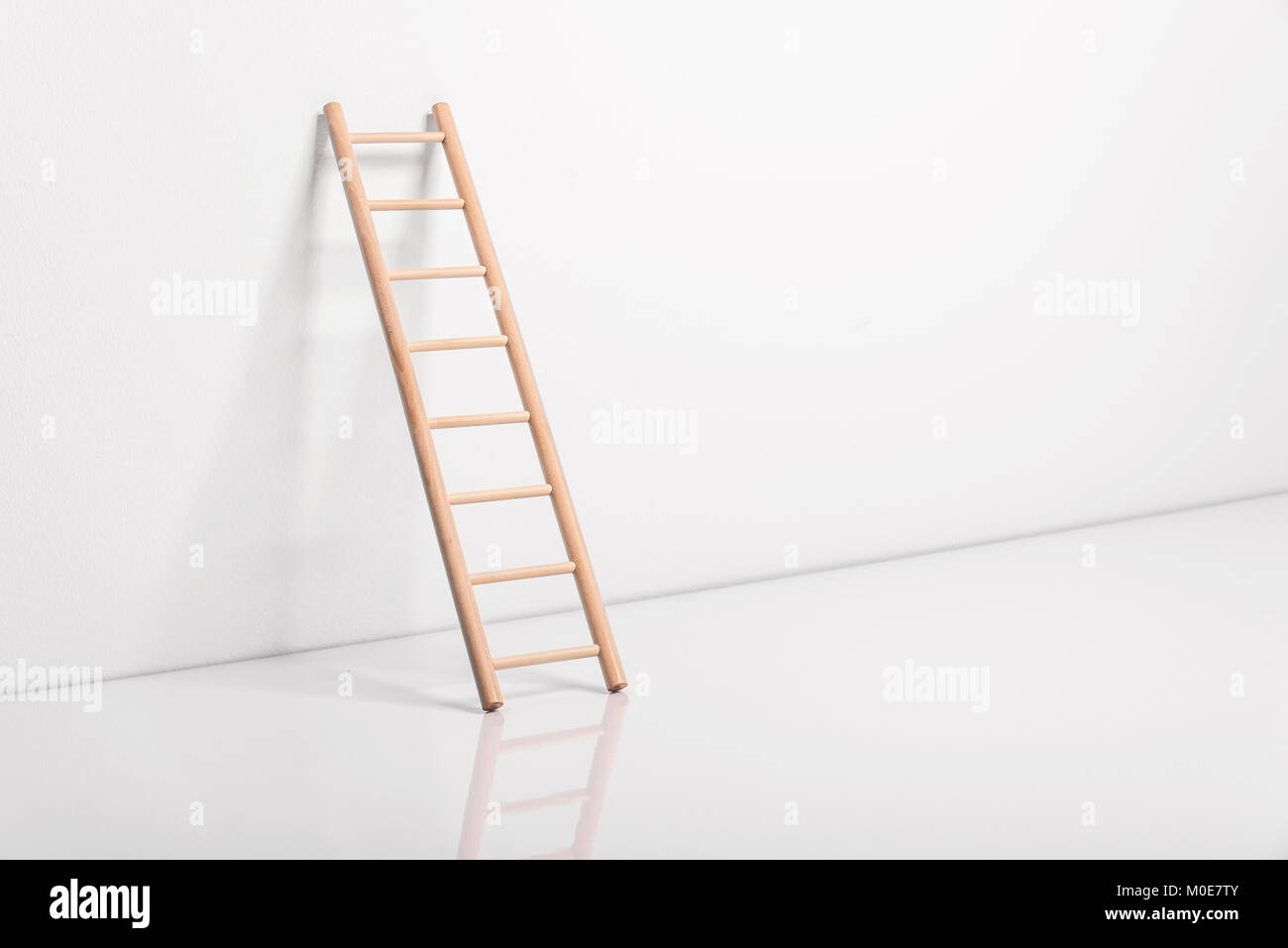 Wooden ladder leaning against the wall Stock Photo - Alamy