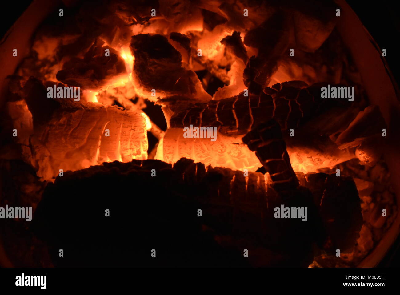 Charcoal burning on stove inside house producing beautiful texture Stock Photo
