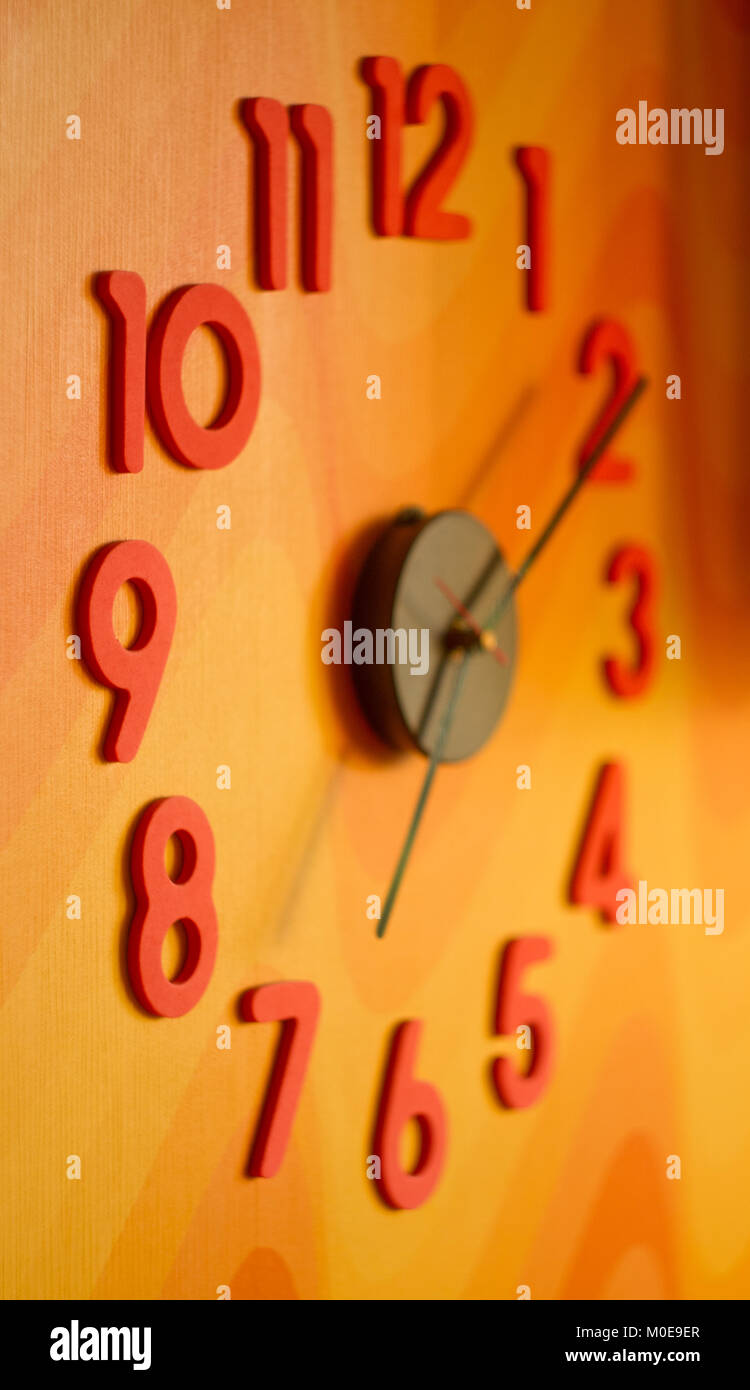 large wall clock with colorful numbers Stock Photo Alamy