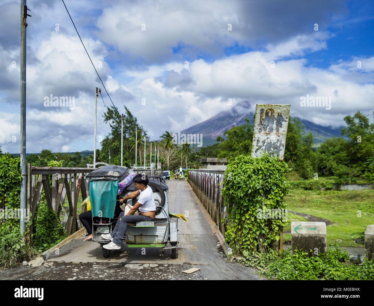 Daraga, Albay, Philippines. 21st Jan, 2018. A tricycle taxi crosses a