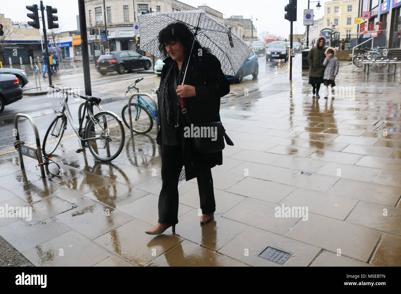 London UK. 21st January Pedestrians are caught in freezing rain and ...