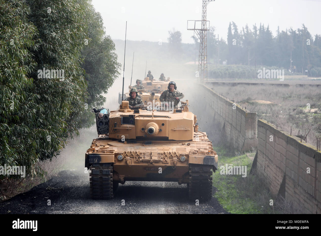 (180121) -- HATAY (TURKEY), Jan. 21, 2018 (Xinhua) -- Turkish armored vehicles head toward Syria's Afrin district from Hatay, Turkey, on Jan. 21, 2018. Turkish ground troops entered Syria's Afrin Sunday on the second day of an offensive against U.S-backed Kurdish militia which should be wrapped up soon, said Turkish President Recep Tayyip Erdogan. (Xinhua) Stock Photo