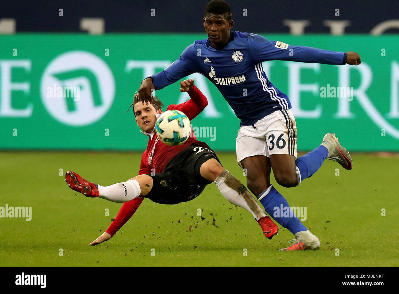 Gelsenkirchen, Germany. 21st Jan, 2018. Oliver Sorg (L) of Hannover and Breel Embolo of Schalke battle for the ball during the Bundesliga match between FC Schalke 04 and Hannover 96 at Veltins-Arena in Gelsenkirchen, Germany, Jan. 21, 2018. Credit: Joachim Bywaletz/Xinhua/Alamy Live News Stock Photo
