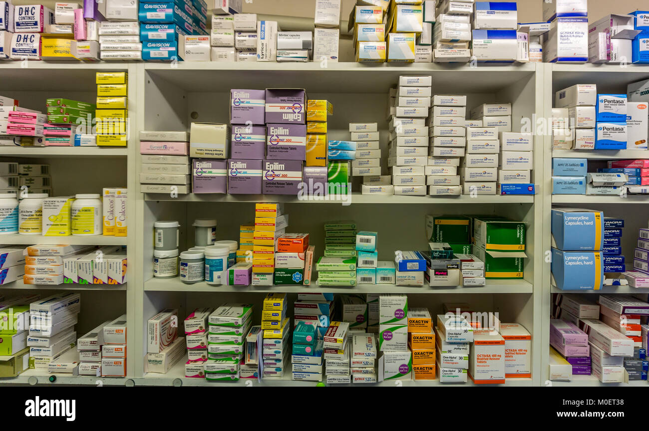 Tablets and drugs on a dispensary shelf in an English Pharmacy. Stock Photo