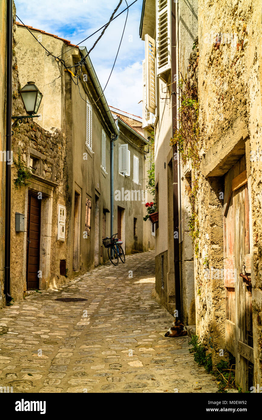 Quiet cobbled old street in Krk town, Croatian island of Krk. Croatia. May 2017. Stock Photo