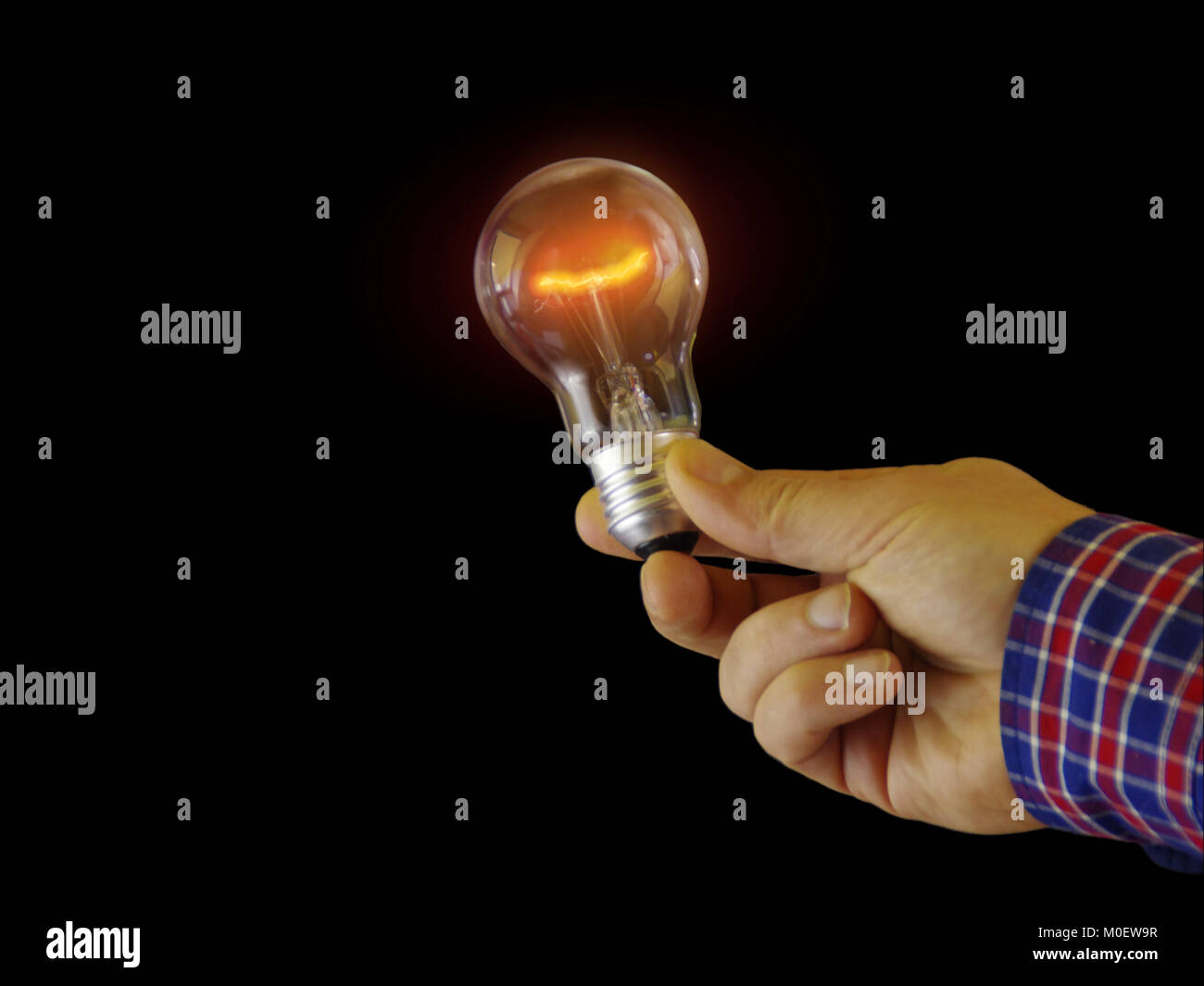 Classic bulb glowing in hand new idea concept. Shine and light around