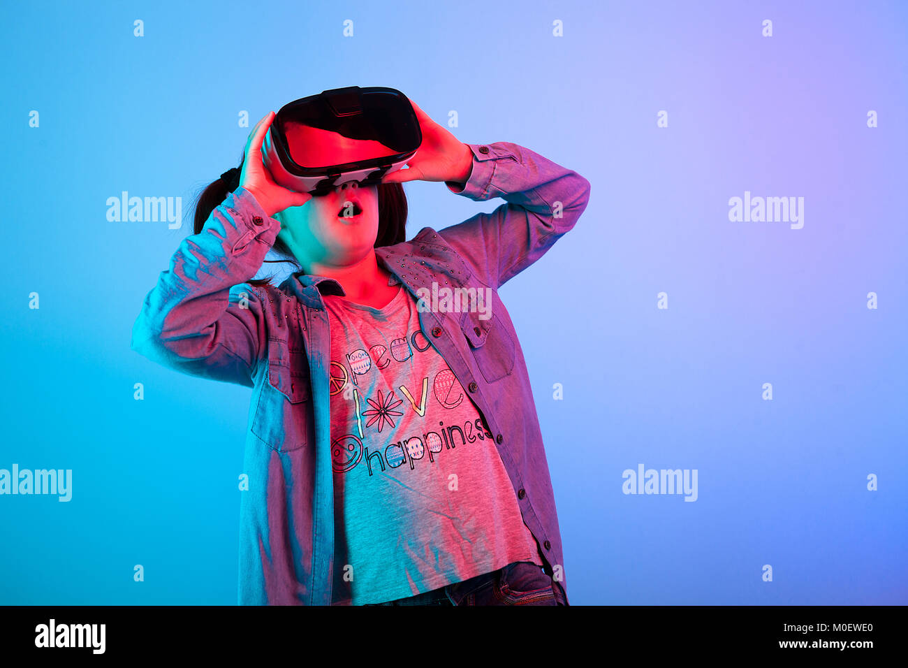 Young girl watching a movie on VR headset Stock Photo Alamy