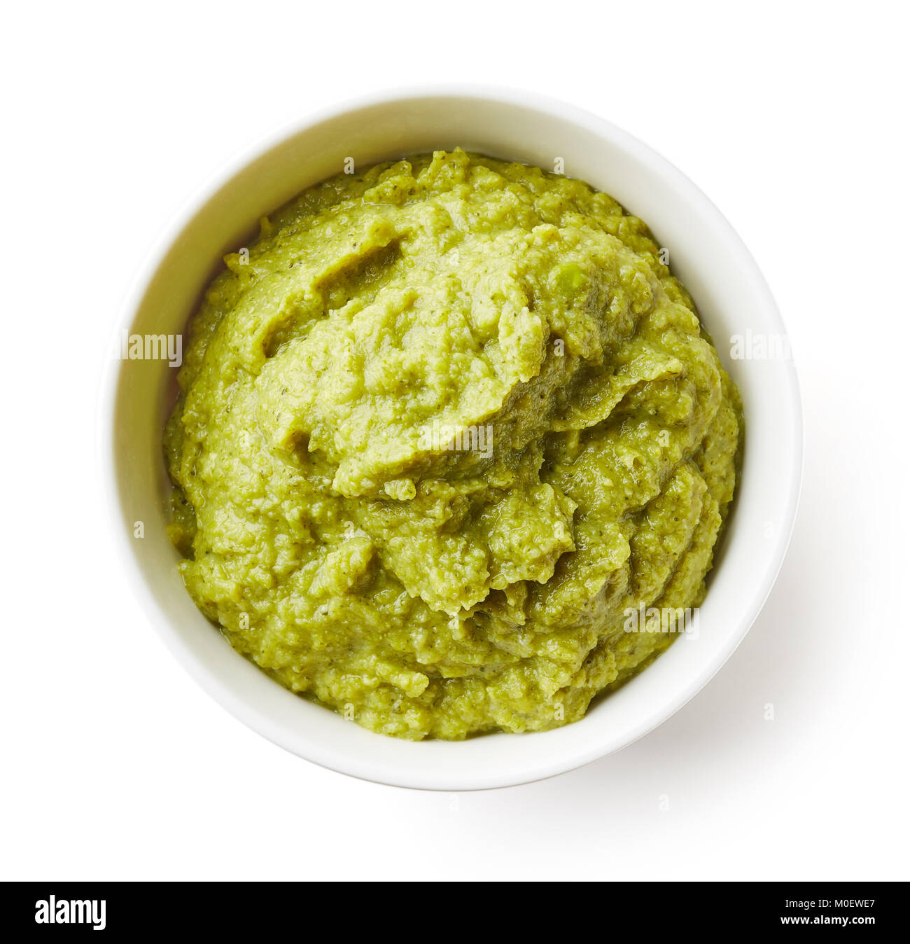 Green peas and broccoli baby puree in bowl isolated on white background