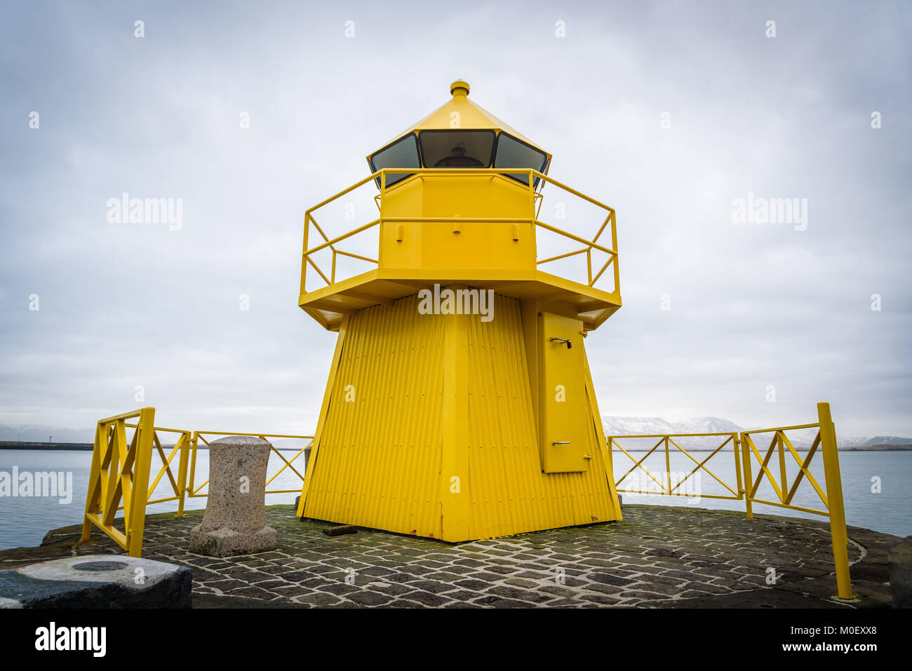 Yellow lighthouse tower at the entrance to the Reykjavik port, Iceland