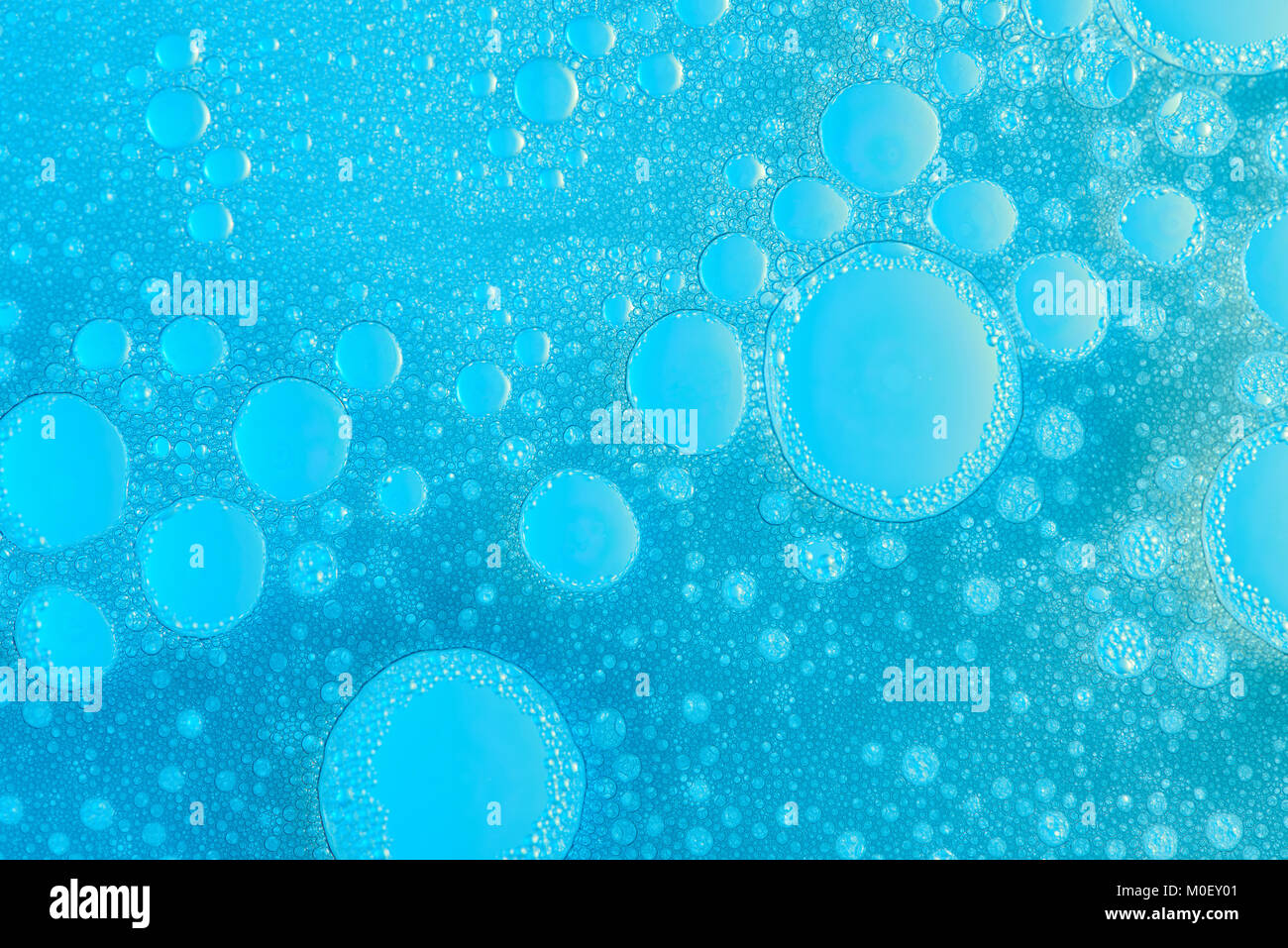 Blue washing liquid bubble background close up. Abstract bubble texture