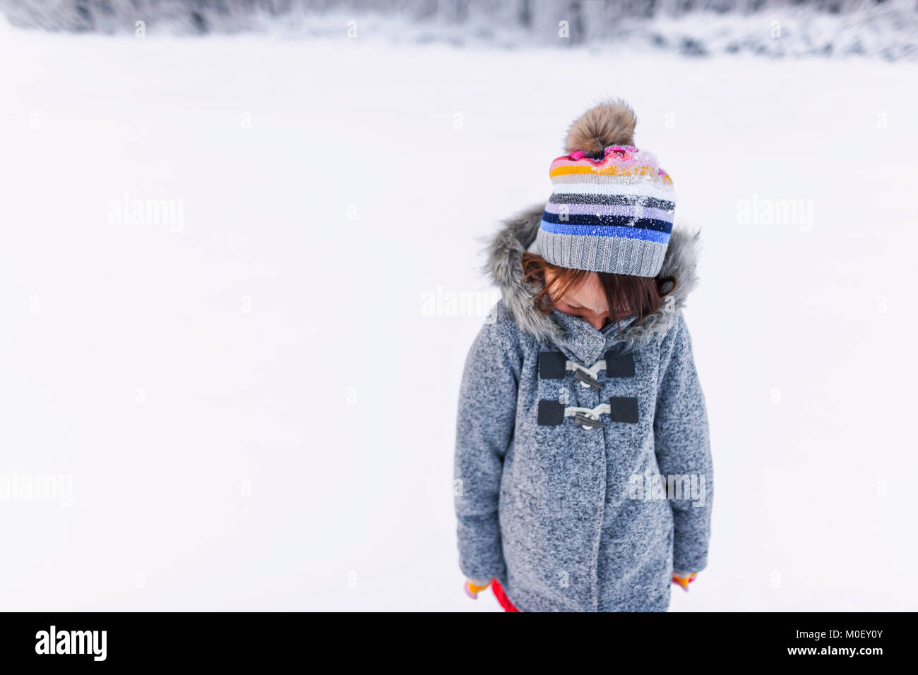 Portrait of a smiling girl standing in the snow Stock Photo - Alamy