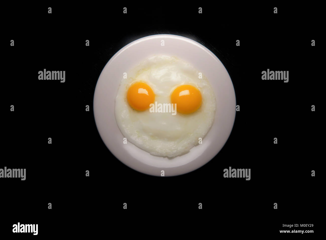 Smiley face made with fried eggs Stock Photo