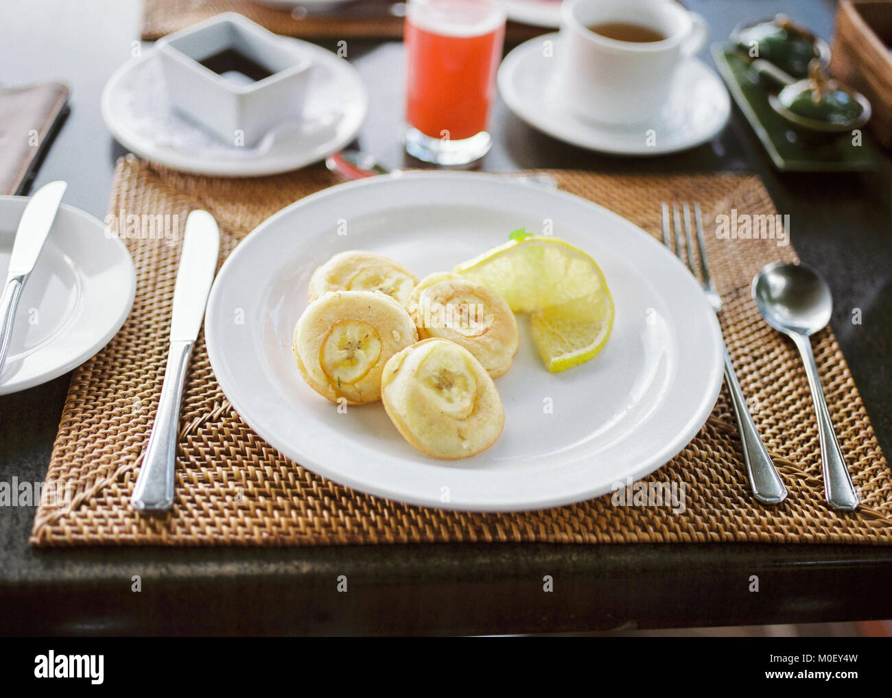 Banana pancakes, tea and grapefruit juice Stock Photo