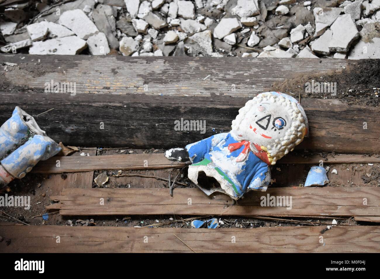 broken doll in abandoned building Stock Photo