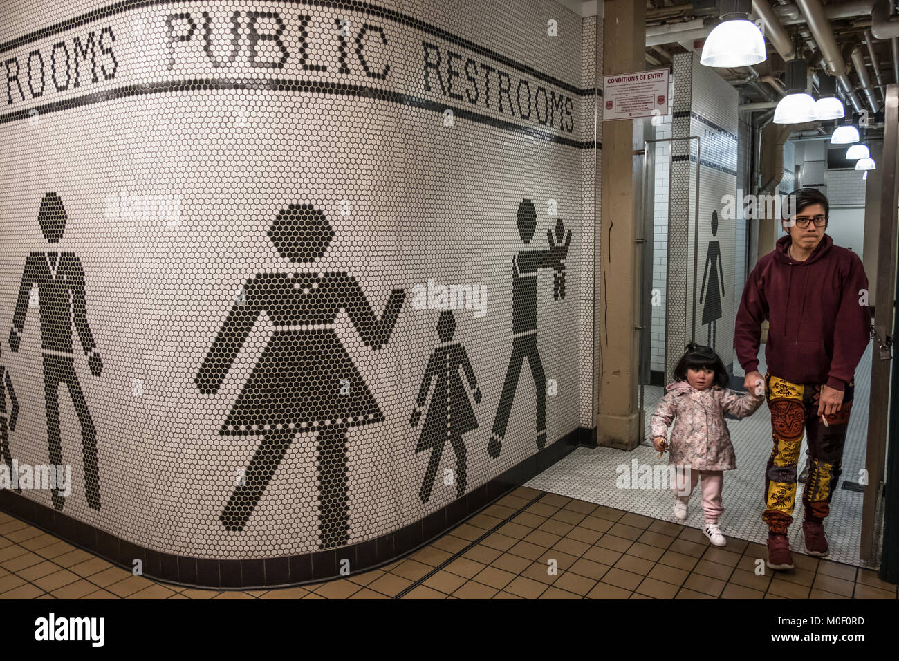 father exiting public restrooms with daughter, Seattle, Washington, USA
