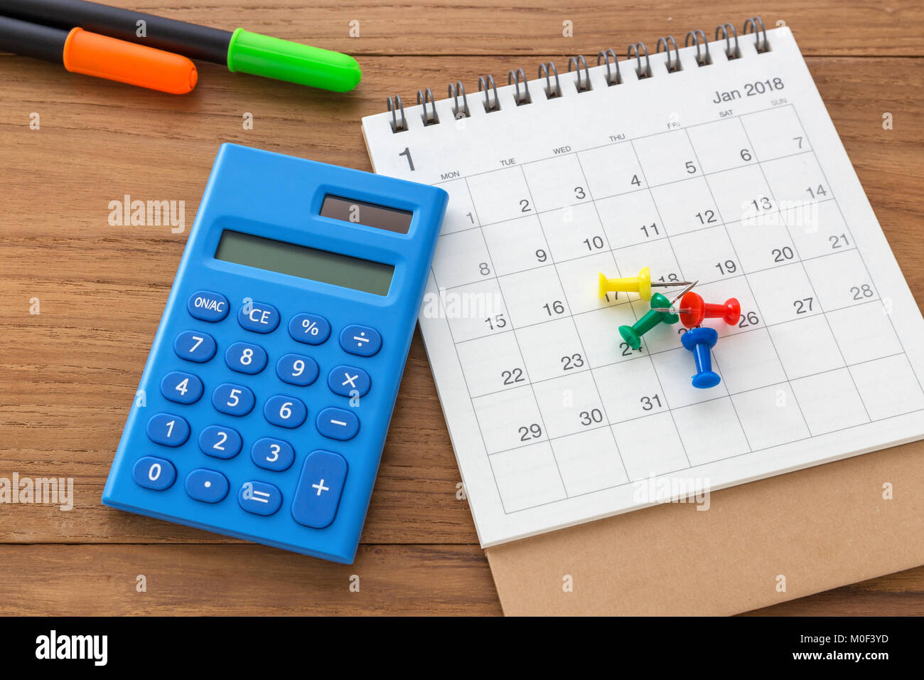Calendar with calculator on wooden table Stock Photo