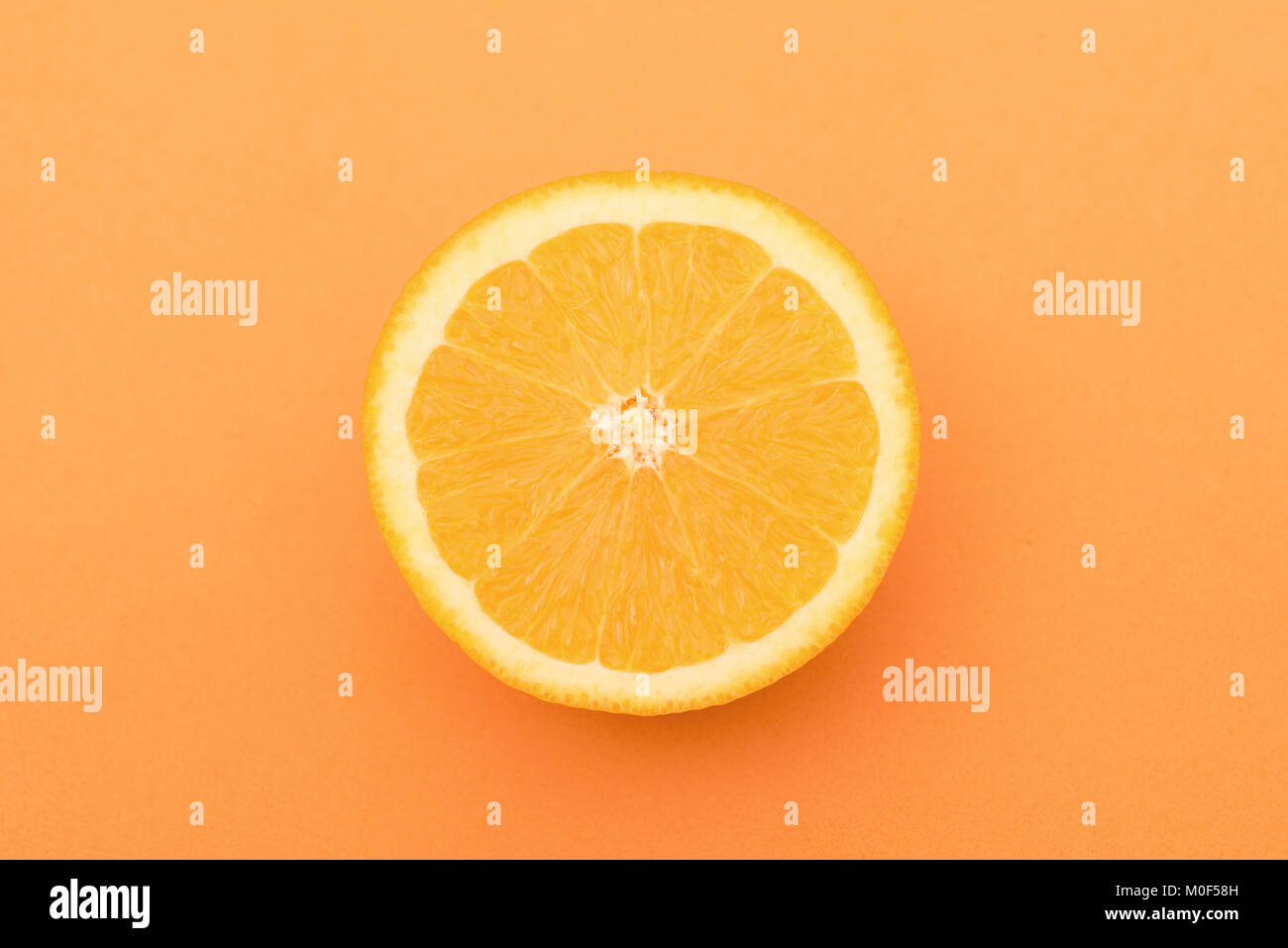 Fresh orange slice isolated on orange background Stock Photo - Alamy
