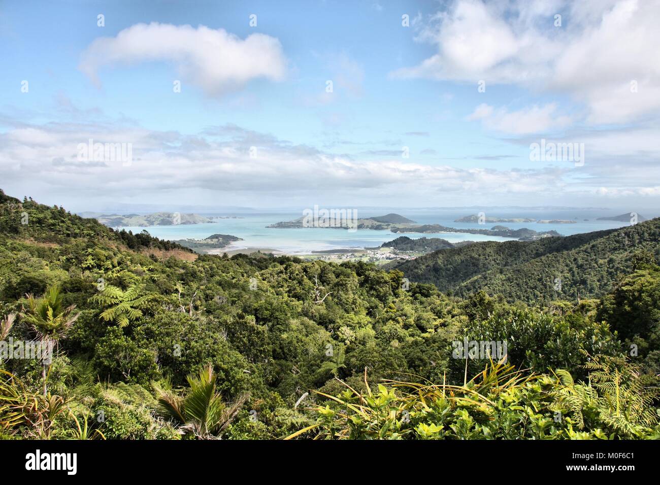 New Zealand natural landscape - aerial view from a temperate rainforest hill towards islands of Coromandel Peninsula. Stock Photo