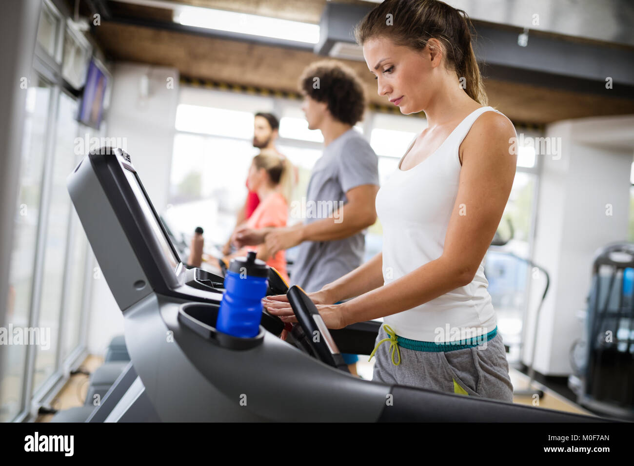 Picture of people running on treadmill in gym Stock Photo Alamy