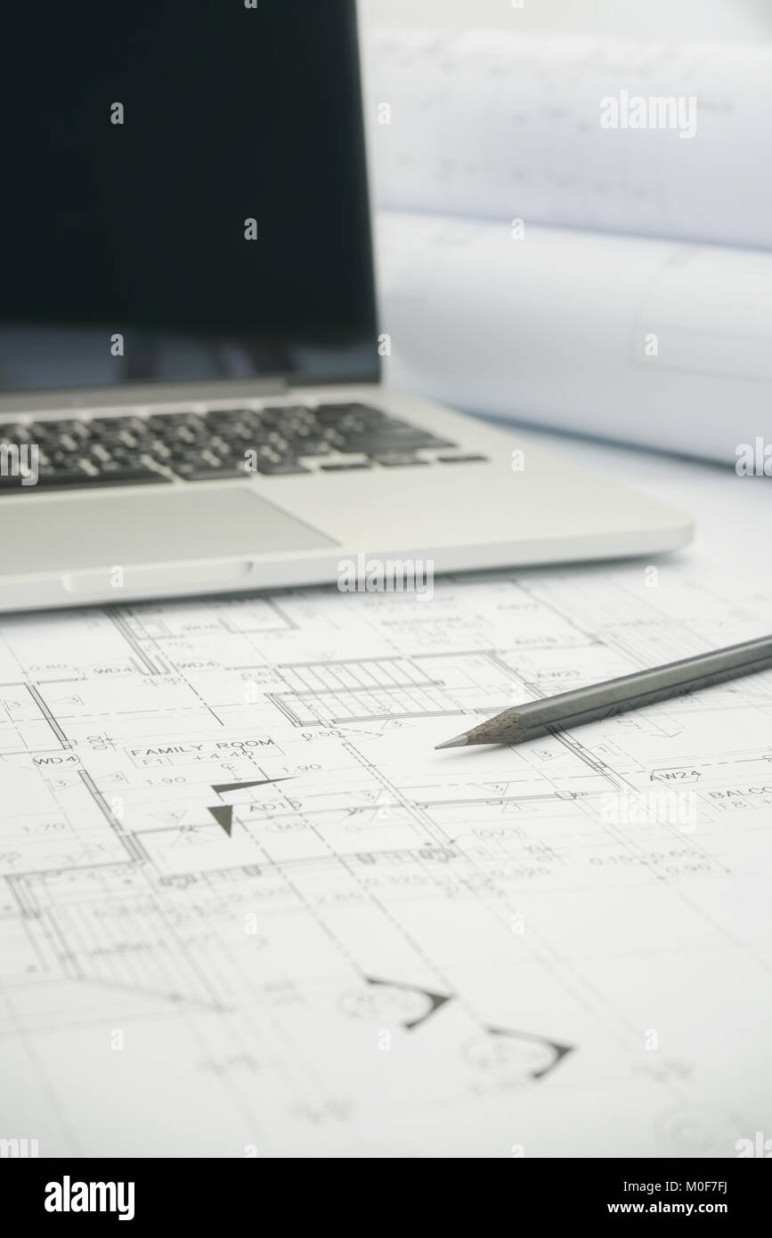 black pencil and computer laptop on architectural drawing paper for ...